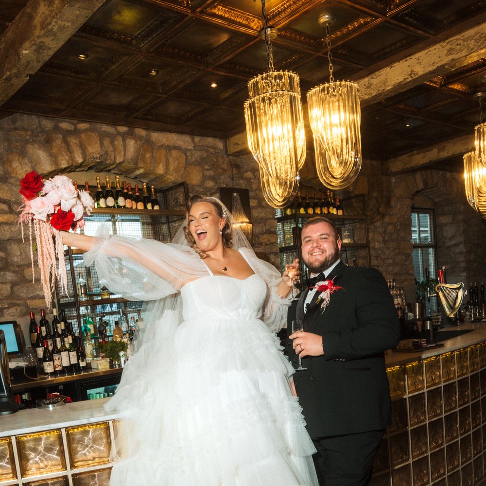 bride and groom celebrating at the bar