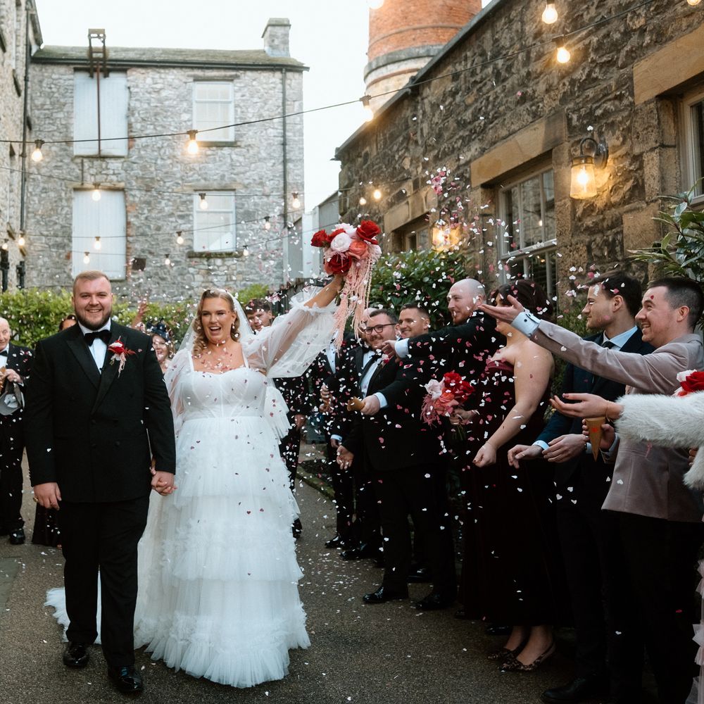 bride and groom pink and red confetti walk