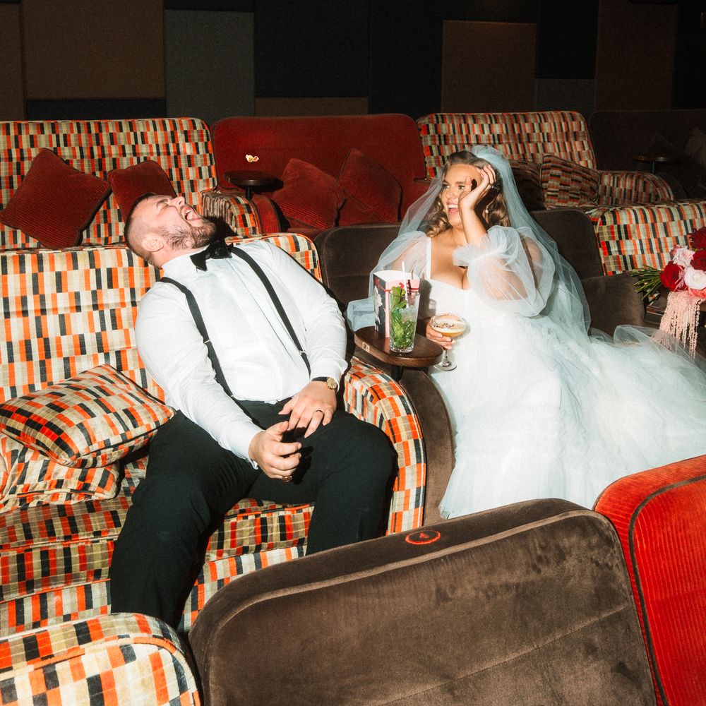 bride and groom share popcorn