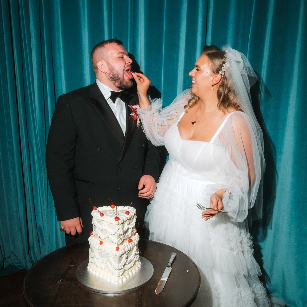 bride feeding groom wedding cake cherry