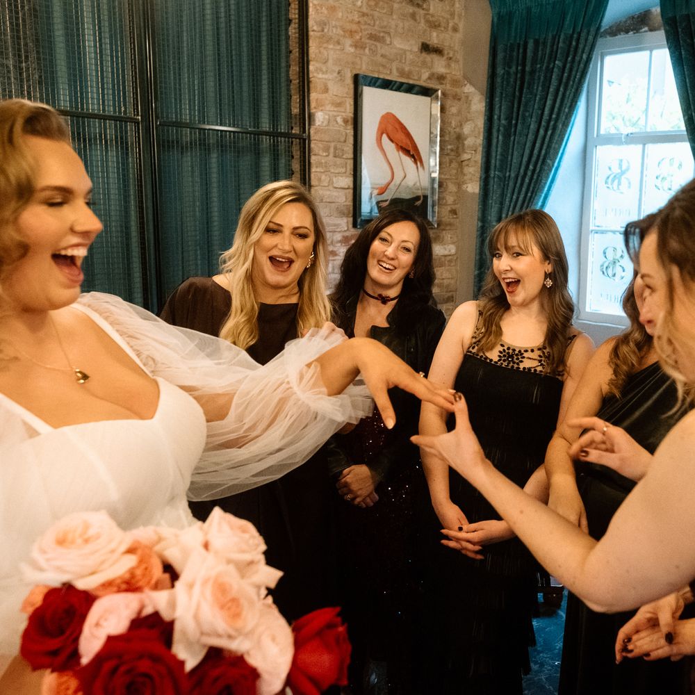 bride shows guests wedding ring