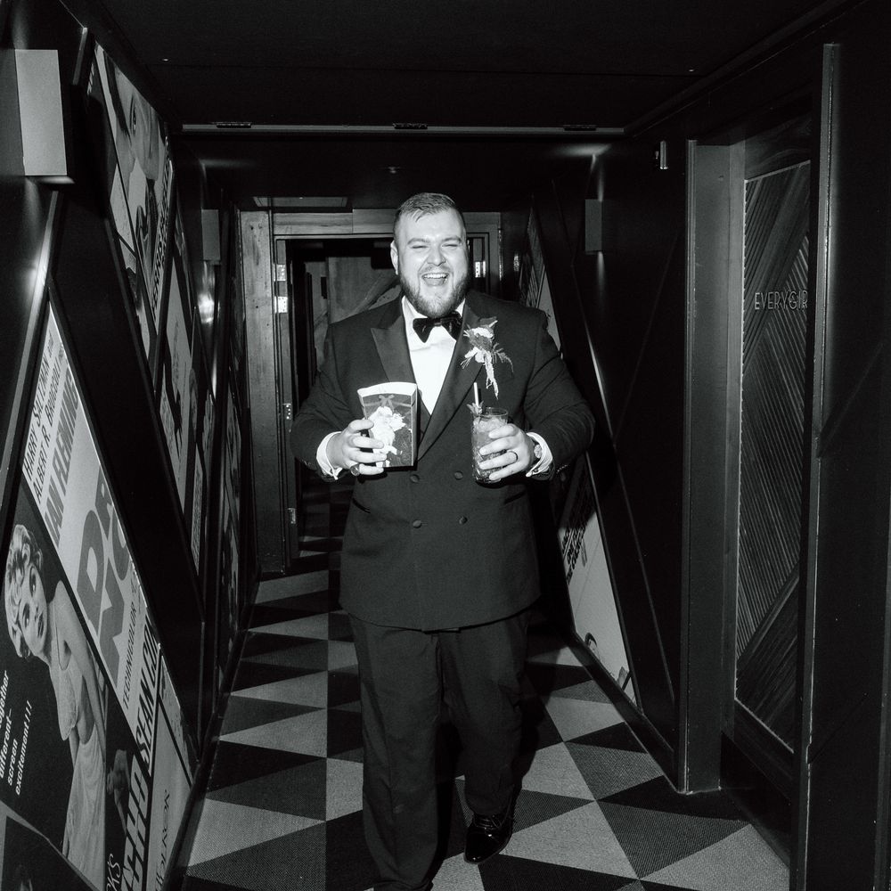 groom smiling with popcorn