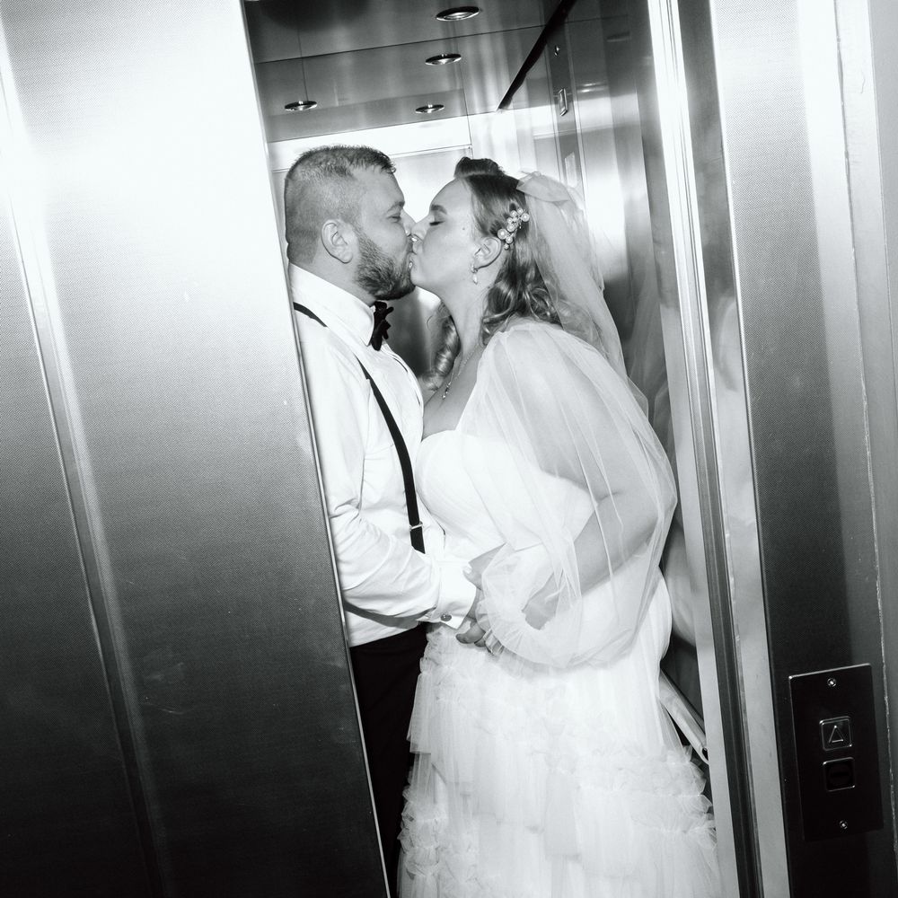 married couple share lift kiss