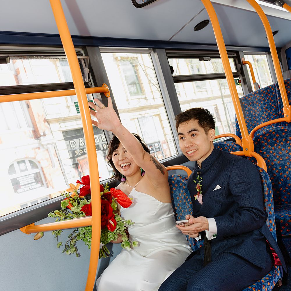 bride and groom ride bus to reception