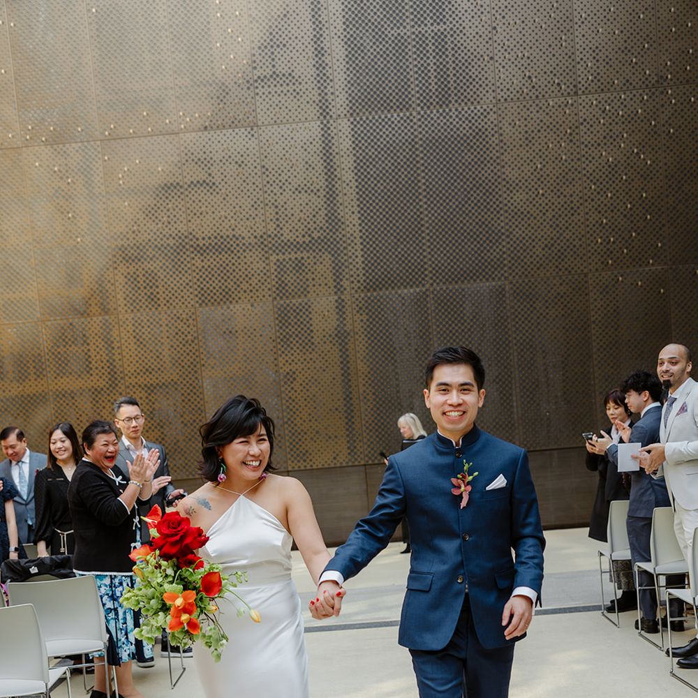 couple walking down aisle as married couple