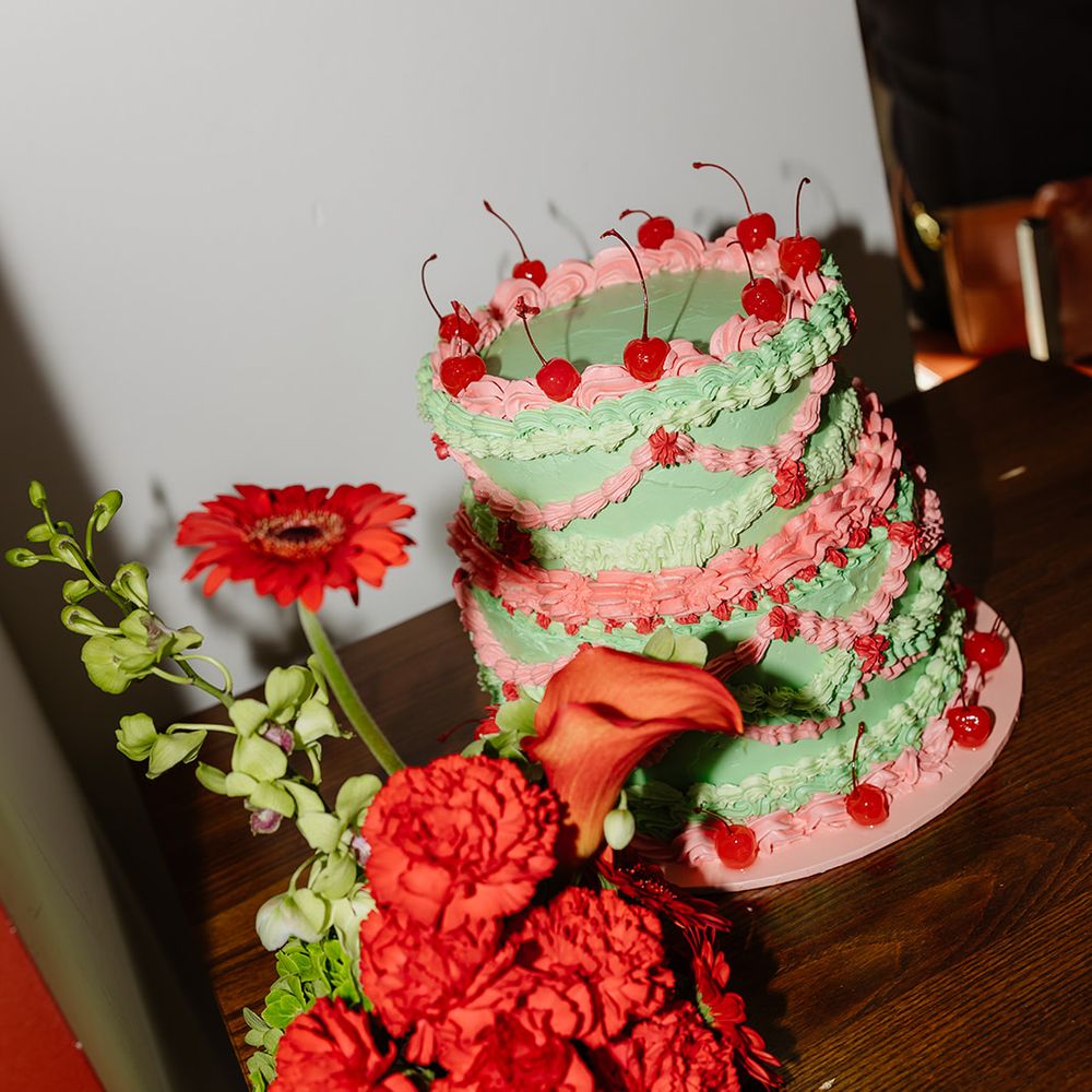red bouquet with pastel green and pink iced cake