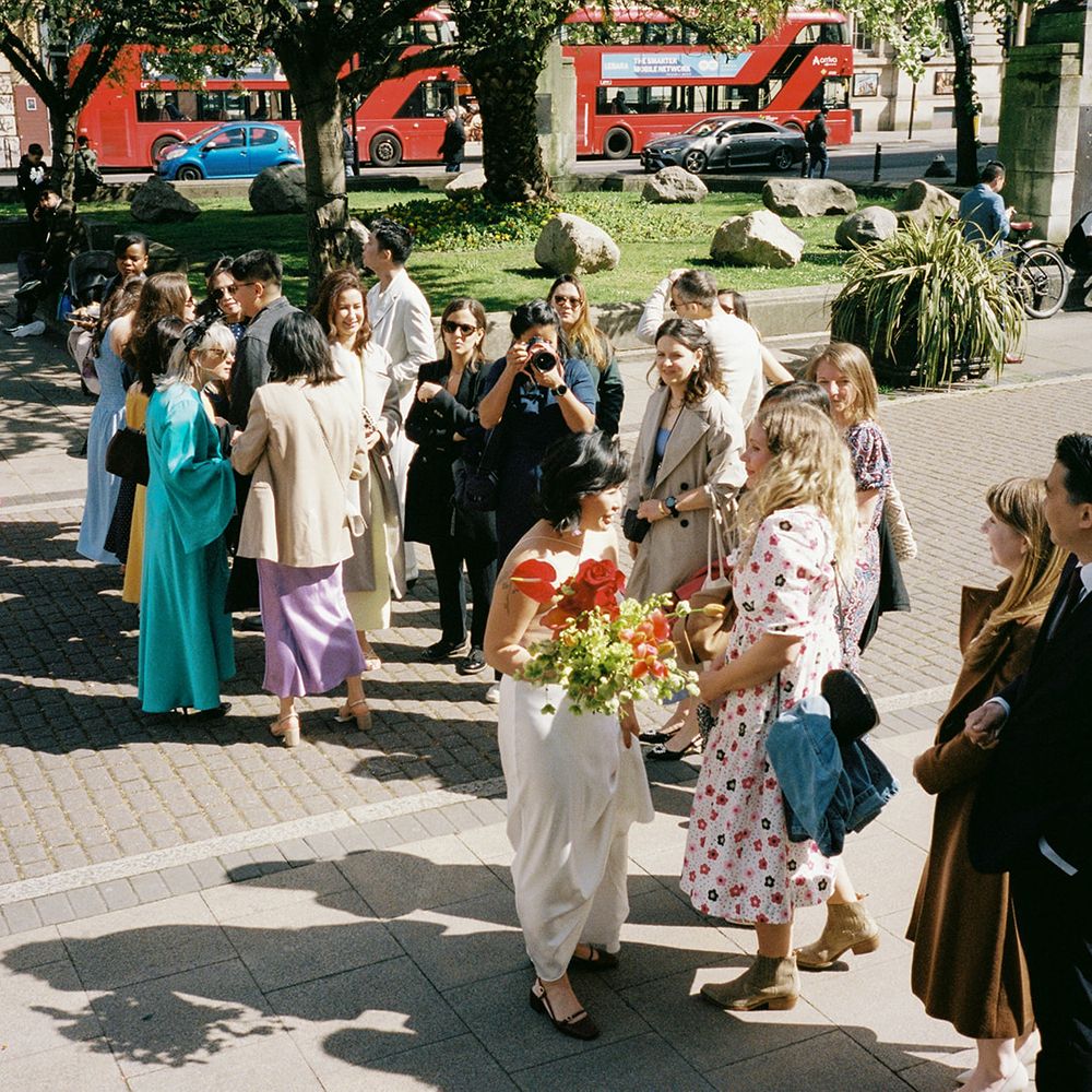 wedding guests gather outside ceremony