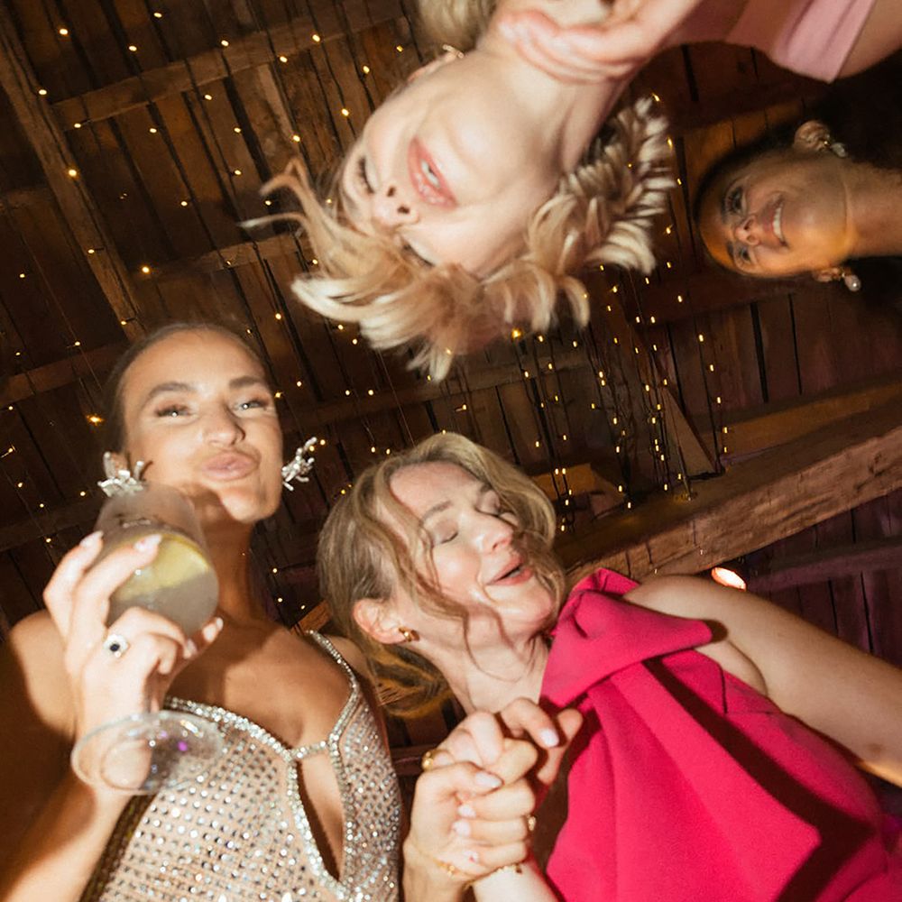 Bride dancing with her bridesmaids at the reception, with something borrowed
