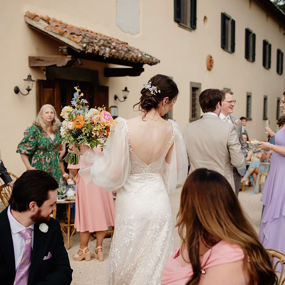 Bride showing guests something borrowed outfit details