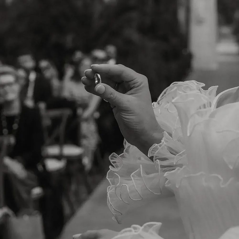 Brand putting on groom's wedding band, as their something new