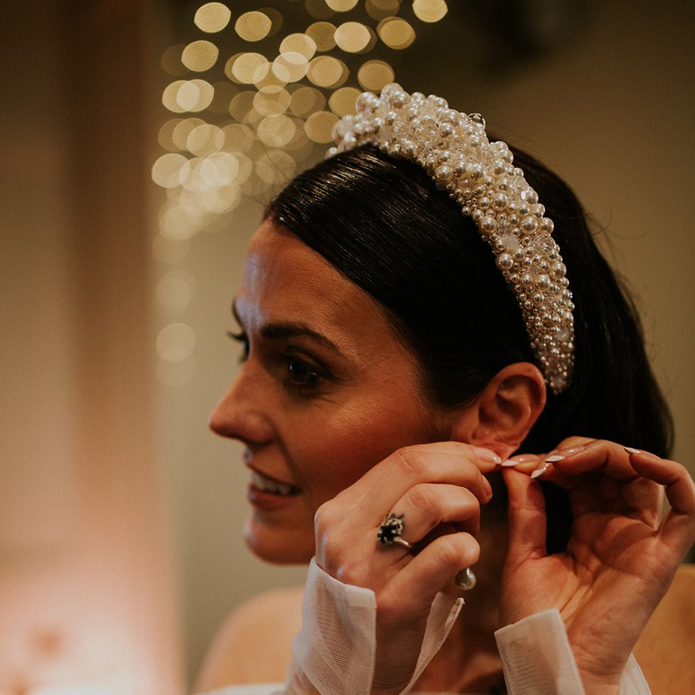 bride getting ready in pearl headband