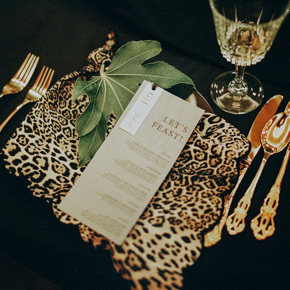 leopard print table decor and gold cutlery