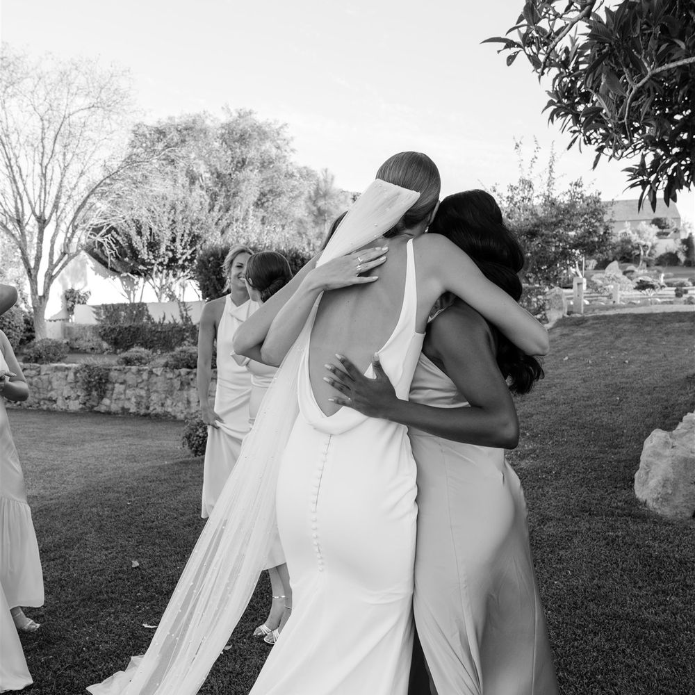 bride hugs bridesmaids