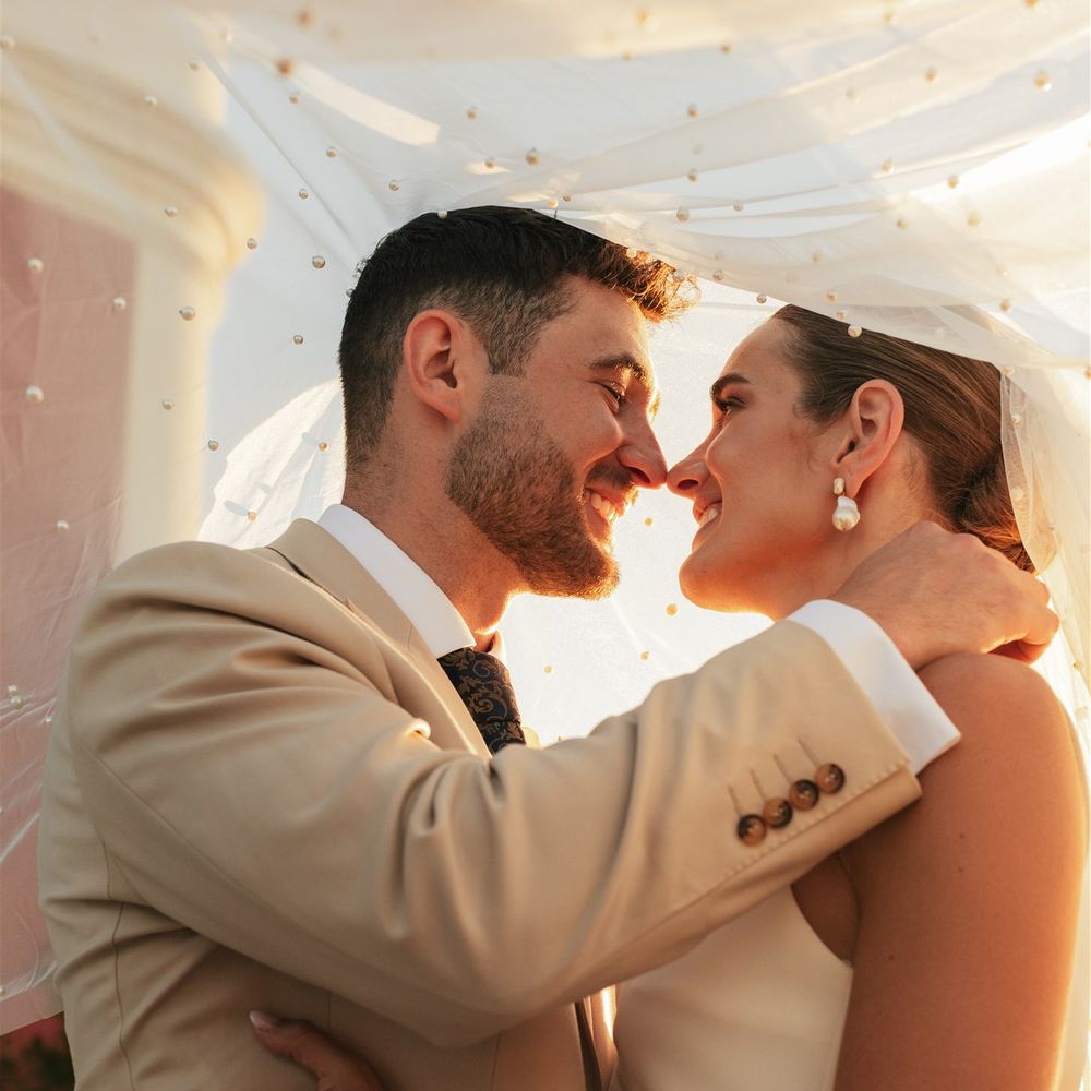 couple under pearl detail veil
