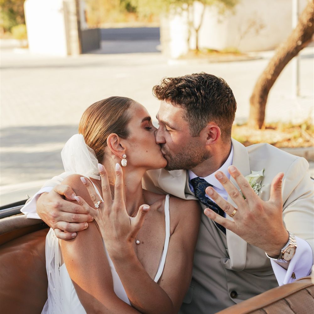 married couple show rings in vintage car