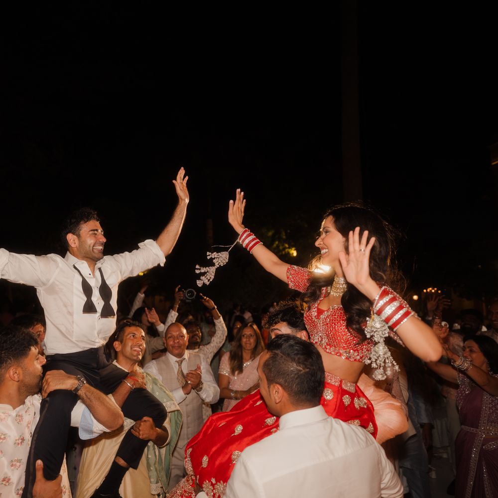 bride and groom lifted up during party