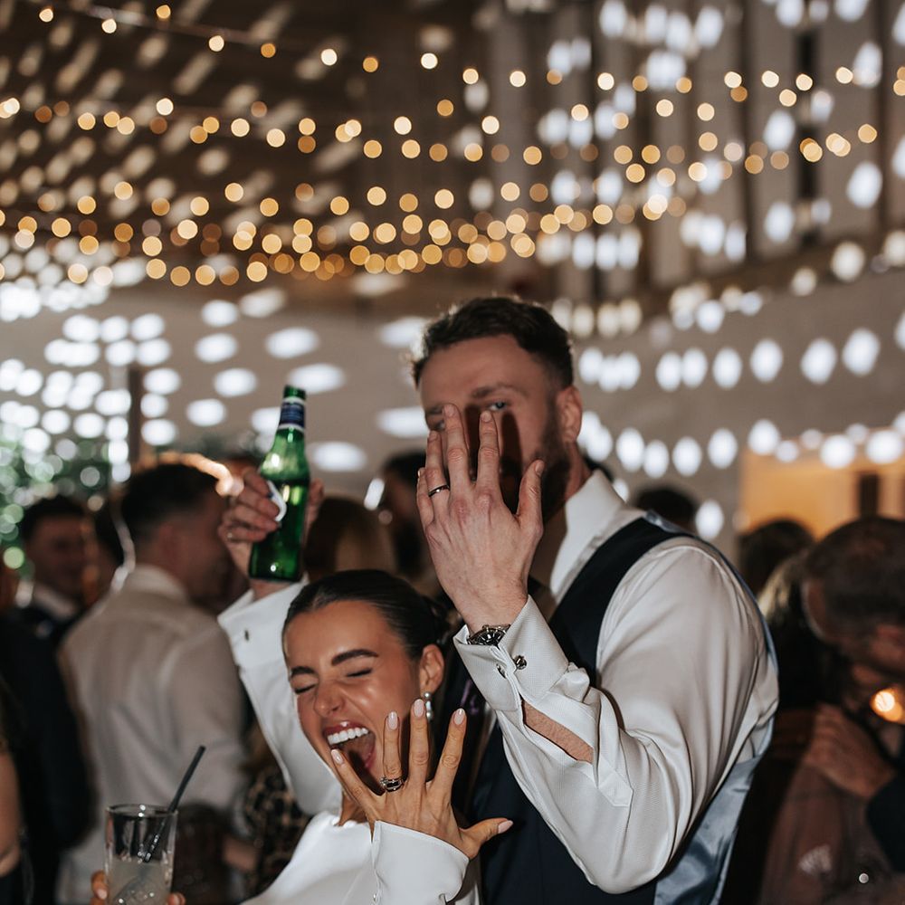 bride and groom dancing partying showing rings