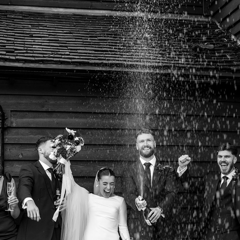 champagne spray black and white photo