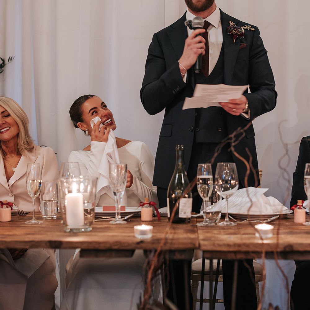 groom speech with bride tearing up