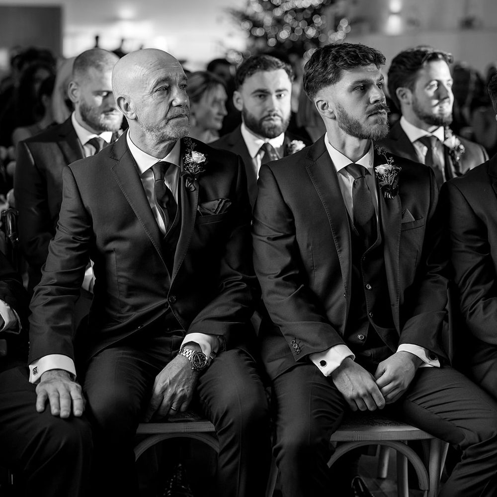 groomsmen emotionally watching ceremony