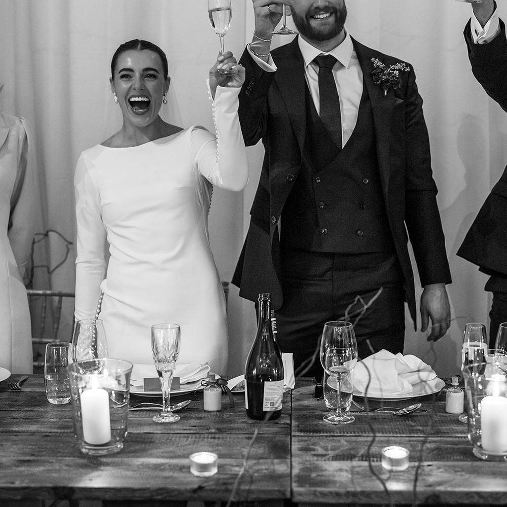 married couple cheers barn wedding