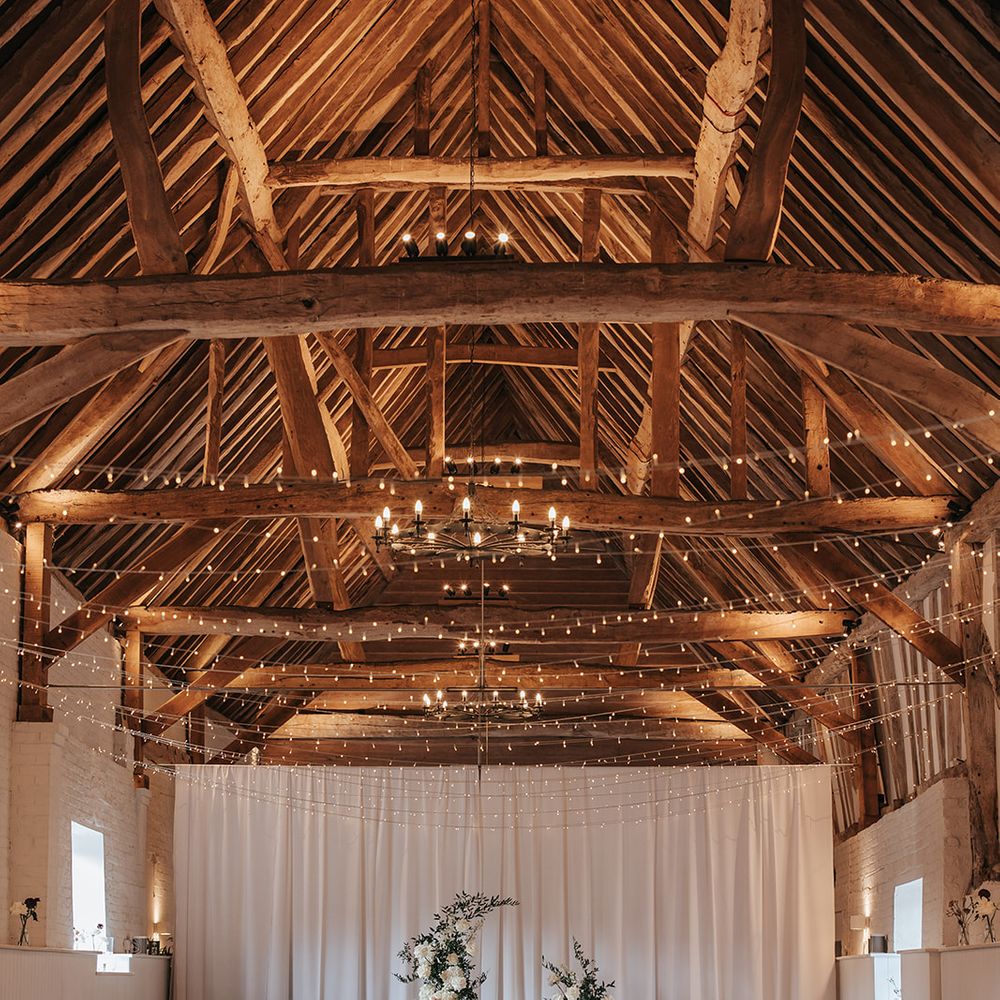 the barn at alswick ceremony setup fairy lights