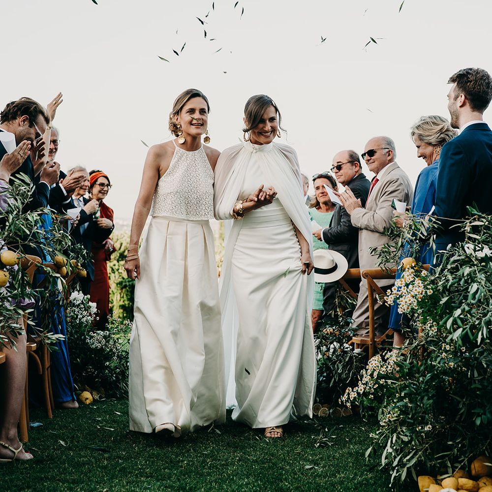 brides as married couple walking through confetti
