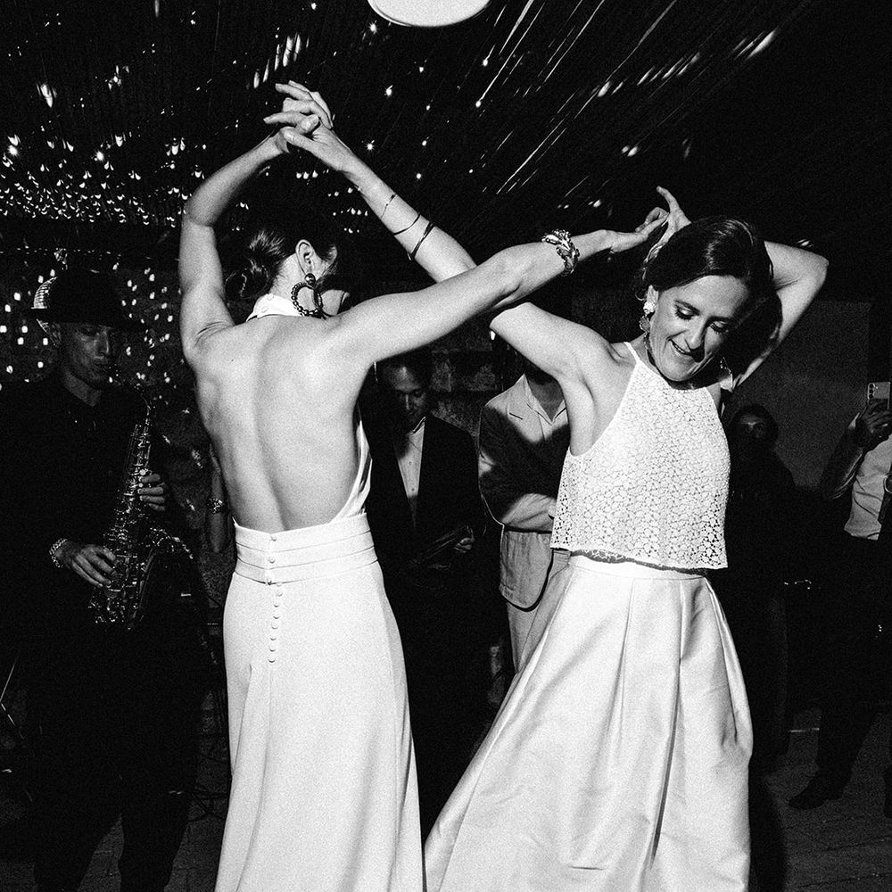 brides dancing together partying