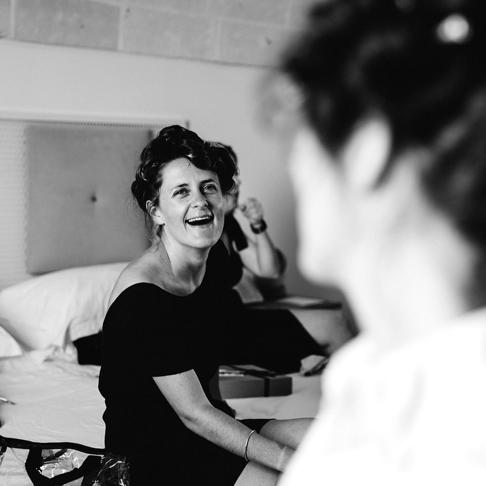 brides getting ready together laughing