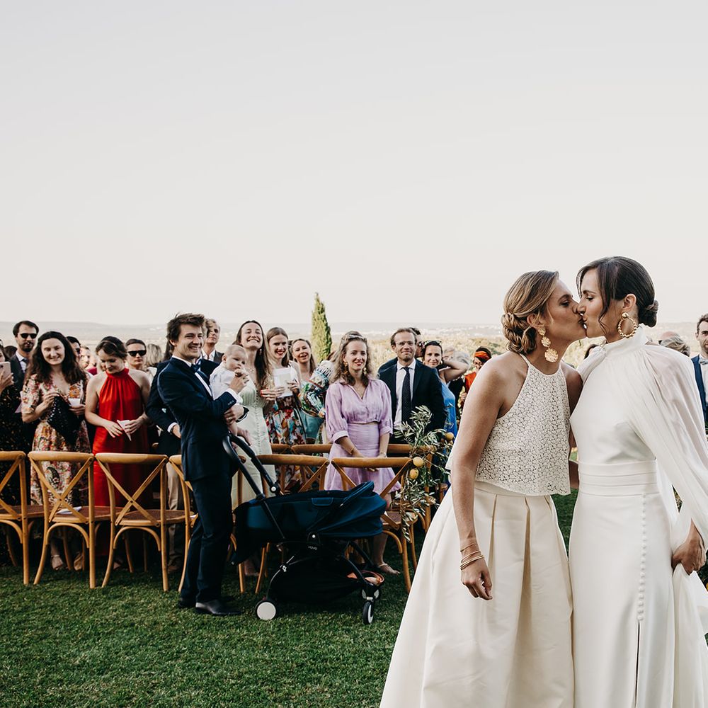 guests watch as brides leave ceremony married