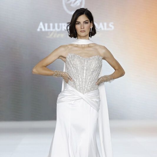 Allure Bridals wedding dress with embellished corset bodice and bridal scarf on the runway at Barcelona Bridal Fashion Week 2026