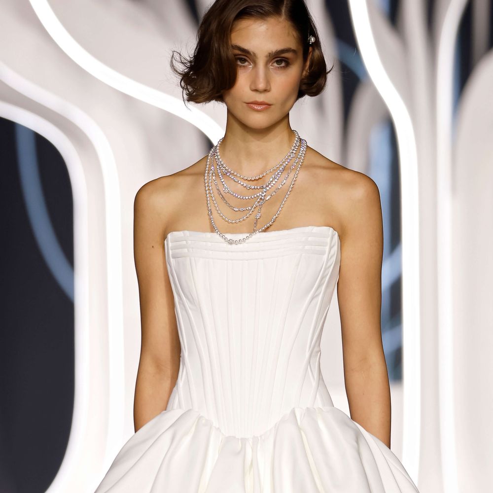 Justin Alexander short corset wedding dress with bubble hem and lace tights on the runway at Barcelona Bridal Fashion Week 2026