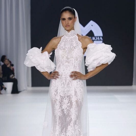 Oksana Mukha lace halter wedding dress with dramatic puff sleeves and veil at Barcelona Bridal Fashion Week 2026