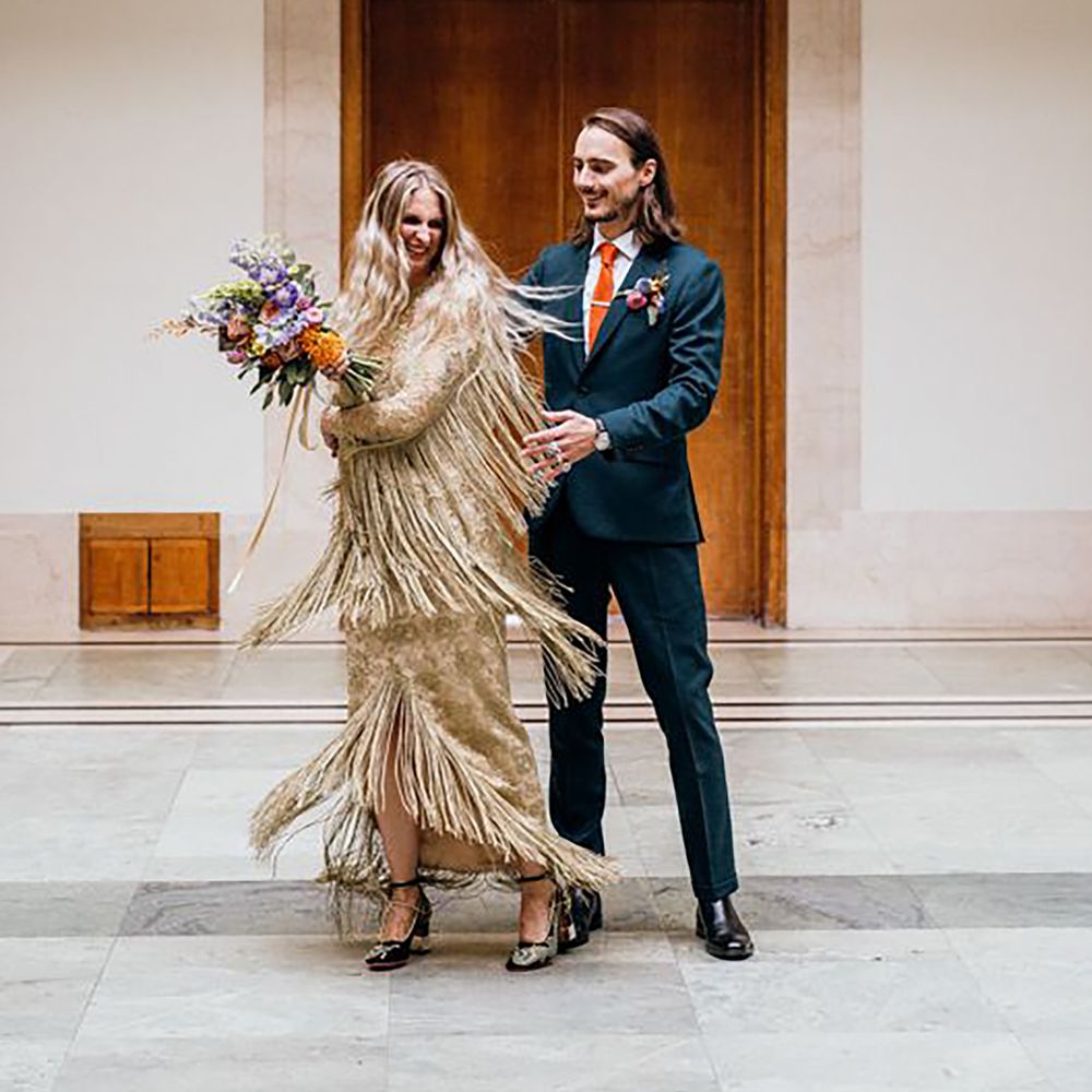 Bride twirling in gold fringe wedding dress