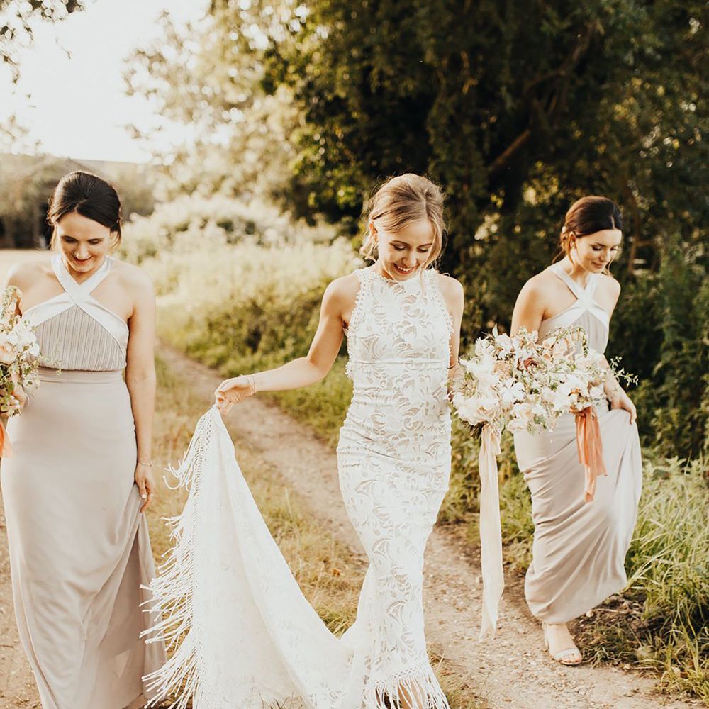 Grace Loves Lace fringe wedding dress with bride holding fringed train