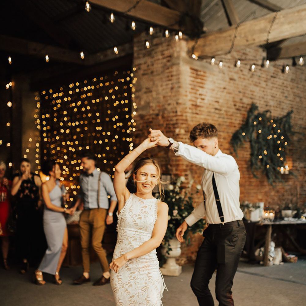 Grace Loves Lace fringe wedding dress, bride twirling on dance floor