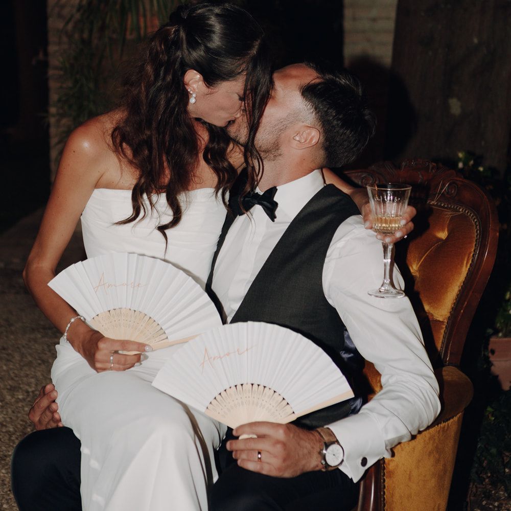 bride and groom night portrait chair fans intimate moment