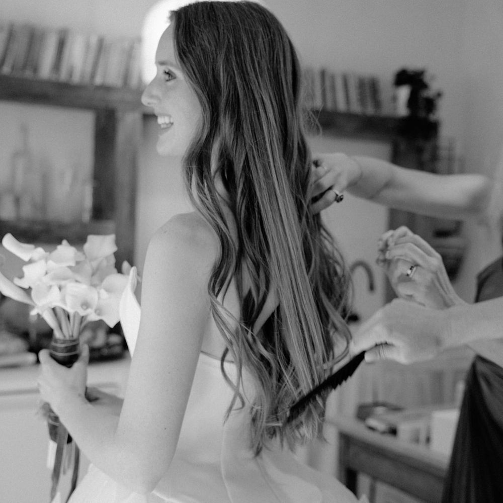 bride holding lillies getting ready