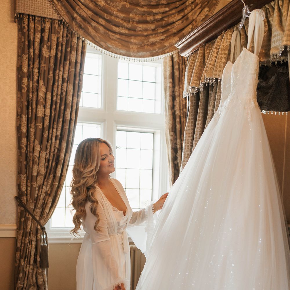 bride admiring sparkly wedding dress