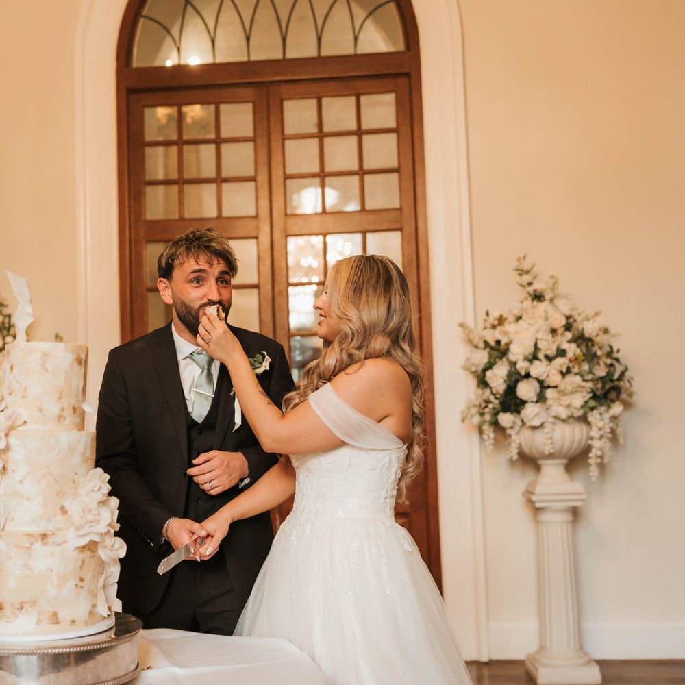 bride feeding groom cake cake cutting