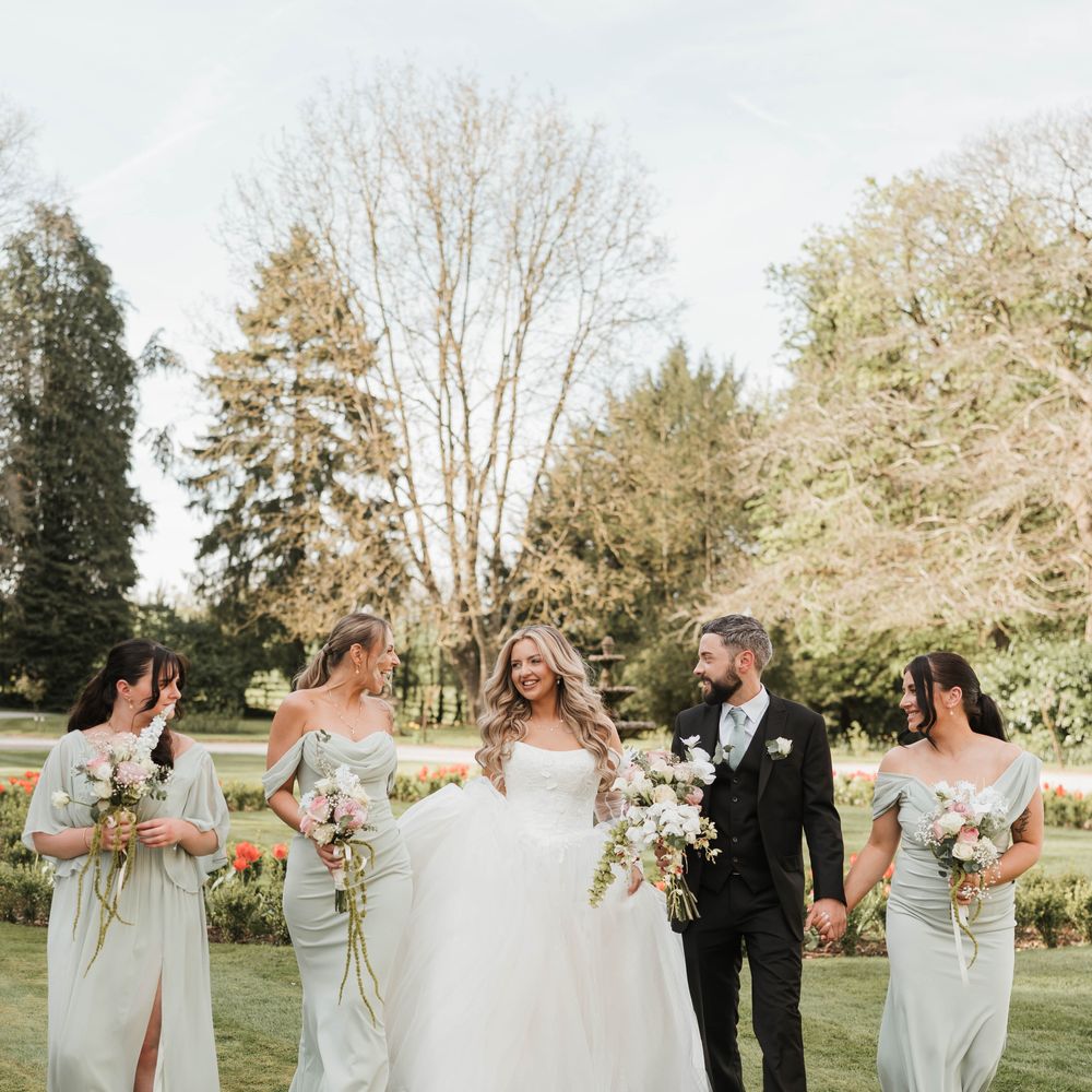 bridesmaids walking castle grounds sage green dresses