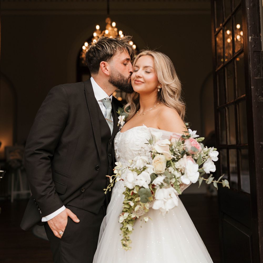 clearwell castle wedding couple kiss chandelier