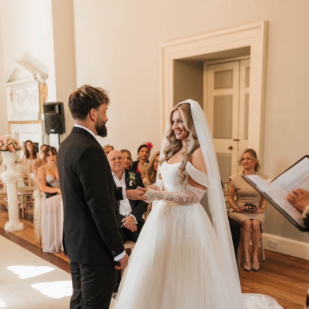 couple reading vows bride princess dress lace sleeves