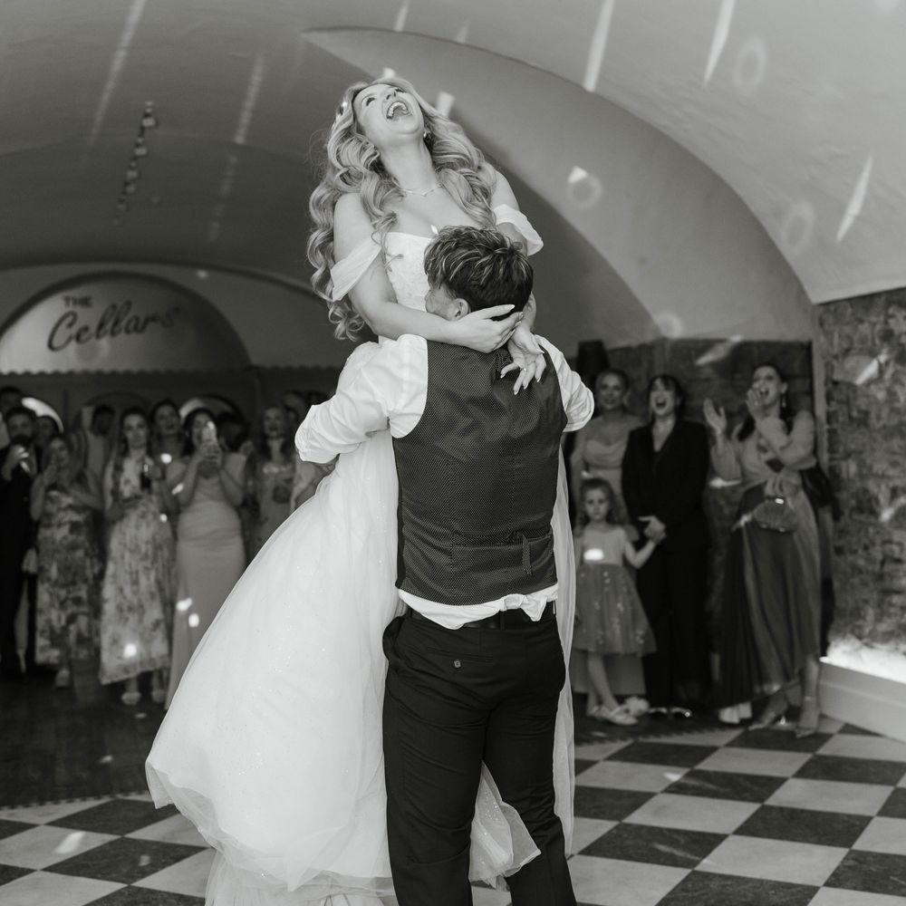 groom lifts bride first dance