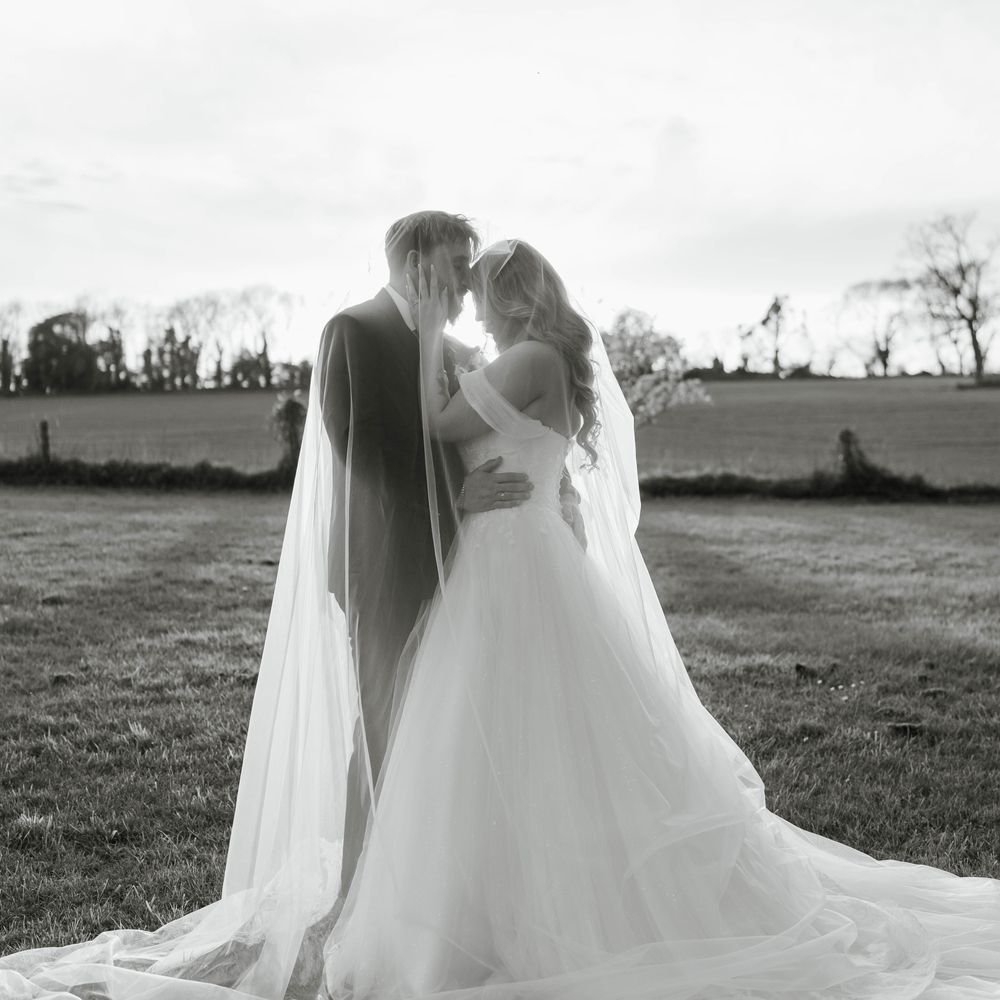 off shoulder wedding dress lace edge veil gardens