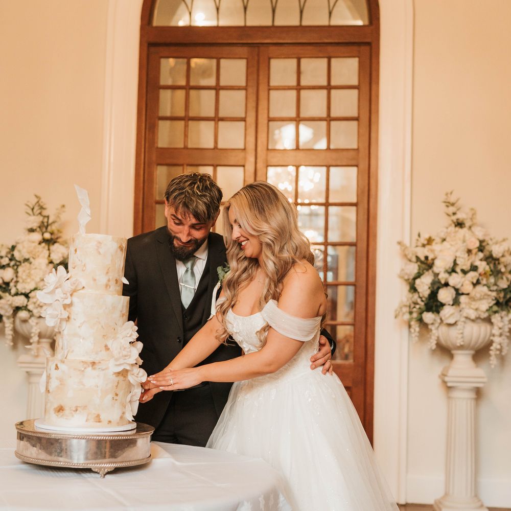 three tiered floral cake cutting