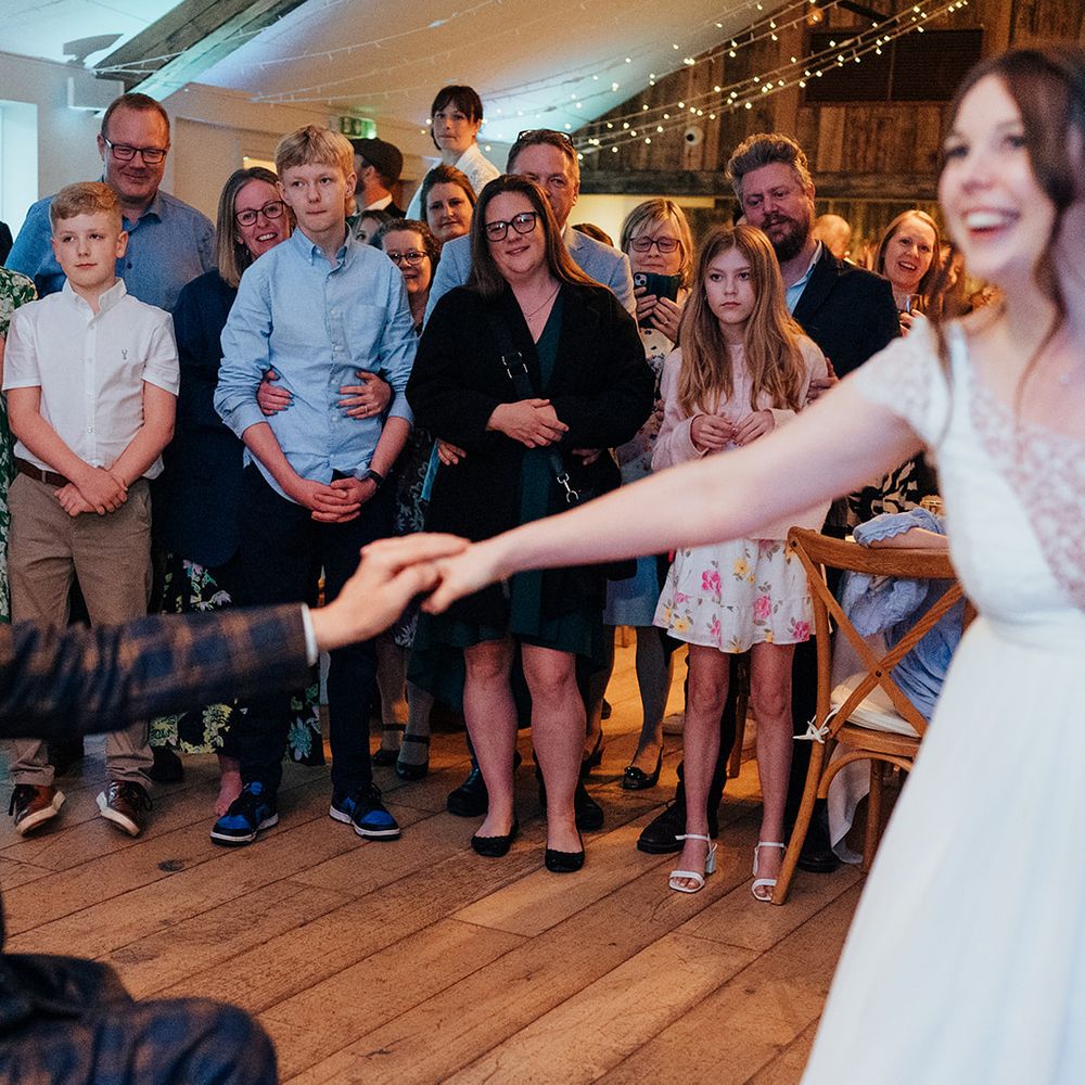 bride groom dance in circle of guests