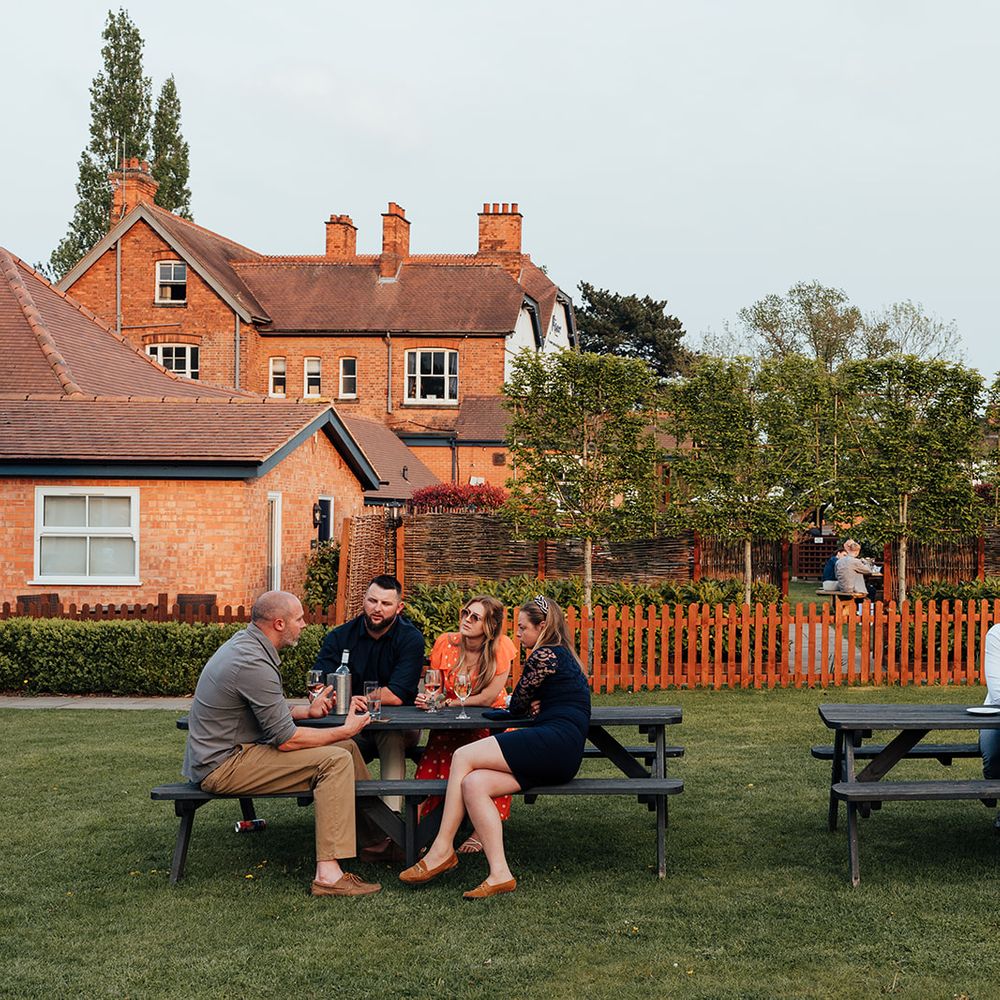 guests enjoying reception outside benches