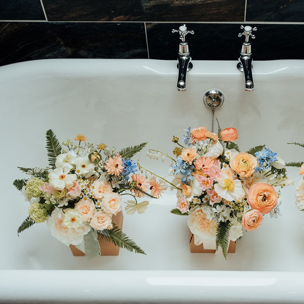 pastel peach blue spring bouquets in bathtub