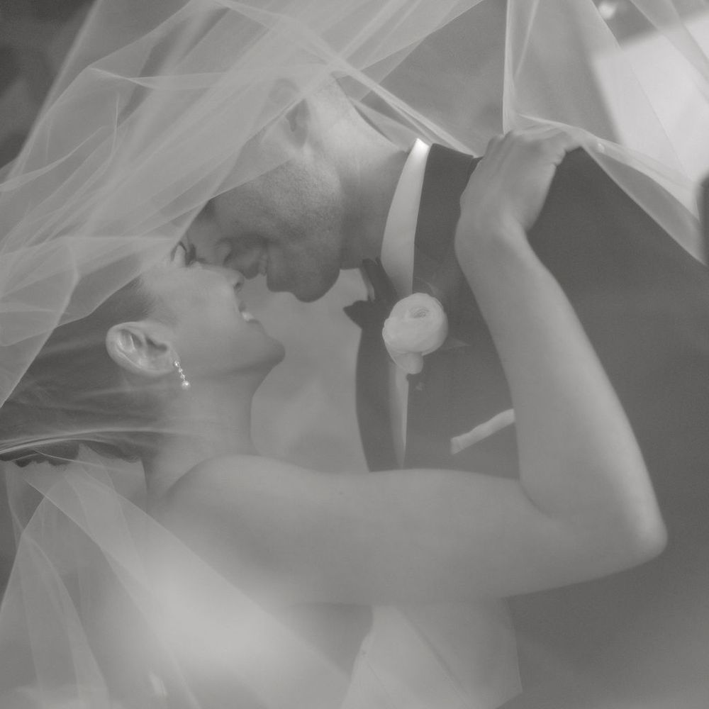 bride groom smile under veil